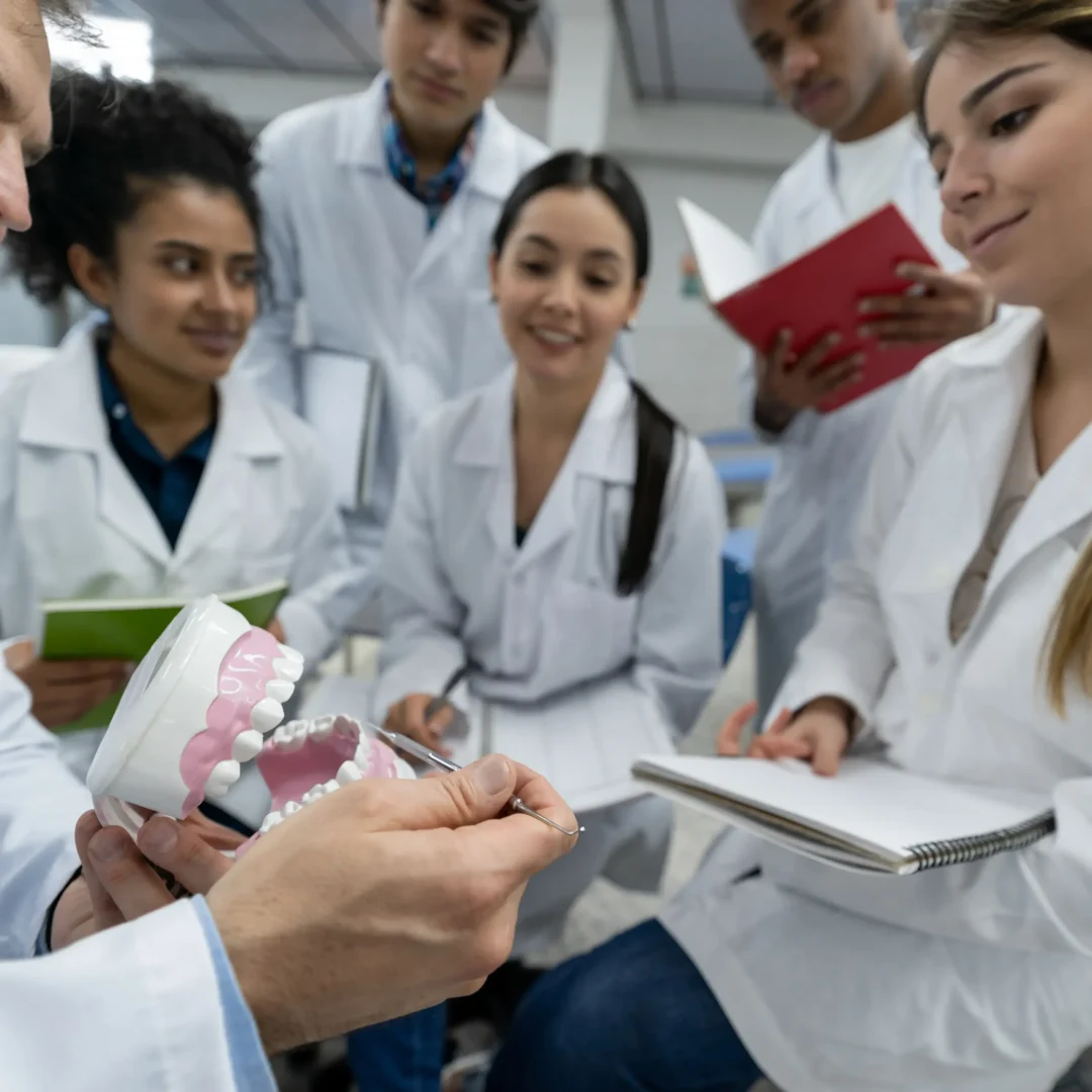 Dentists learning advanced techniques during a GADE masterclass in Greece.